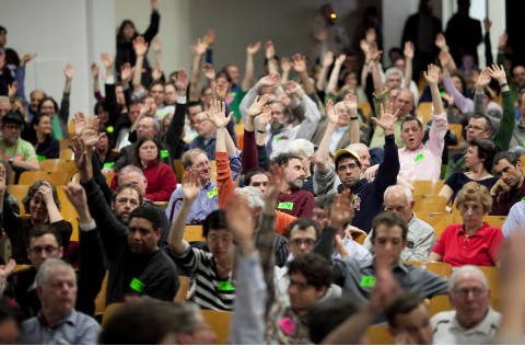 PB event in Scotland Community members raise hands at participatory budgeting event