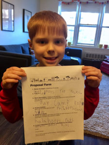Student holding idea submission form
