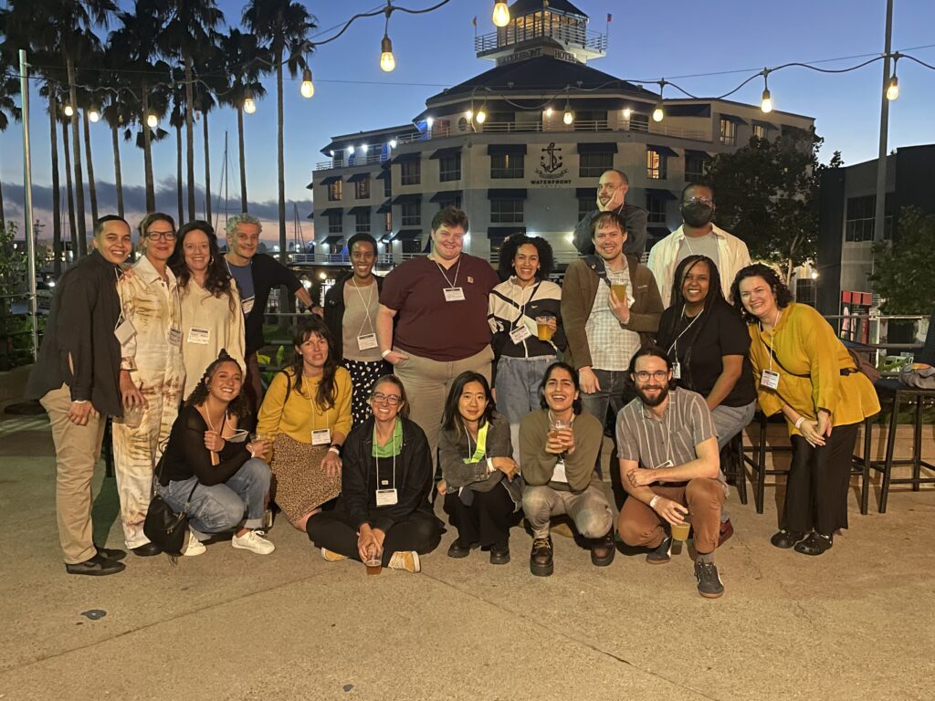 PBP Staff pose for group picture against outdoor sunset